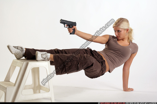 executing a dynamic action pose while brandishing a gun