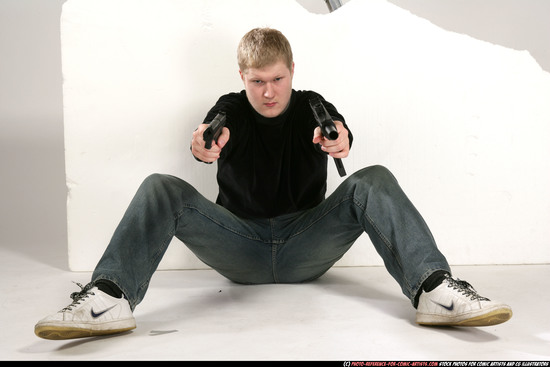 Man Young Average White Fighting with gun Sitting poses Sportswear