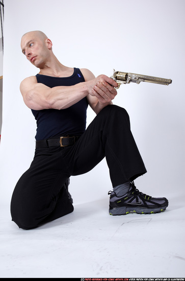 Man Adult Muscular White Fighting with gun Kneeling poses Sportswear