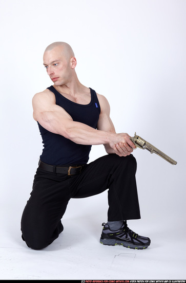 Man Adult Muscular White Fighting with gun Kneeling poses Sportswear