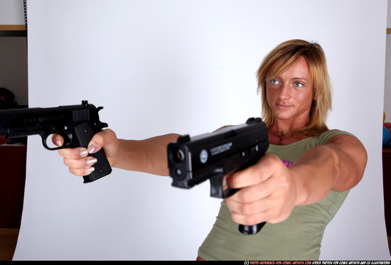 Woman Adult Muscular White Fighting with gun Sitting poses Sportswear