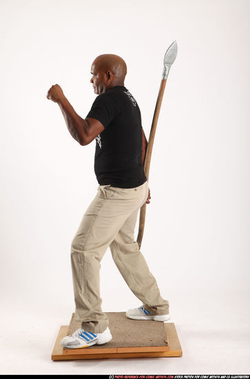 Man Old Average Black Fighting with spear Standing poses Casual