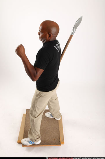 Man Old Average Black Fighting with spear Standing poses Casual