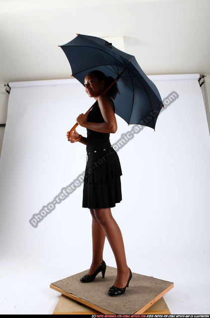 Adorable little girl posing with umbrella in park Stock Photo - Alamy