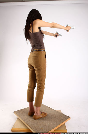 Woman Young Athletic Fighting with gun Standing poses Casual Asian