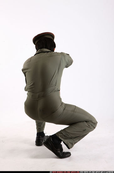 Man Adult Average Fighting with submachine gun Kneeling poses Army Asian