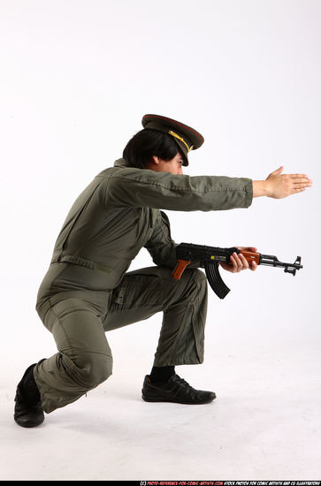 Man Adult Average Fighting with submachine gun Kneeling poses Army Asian