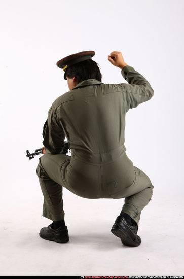 Man Adult Average Fighting with submachine gun Kneeling poses Army Asian