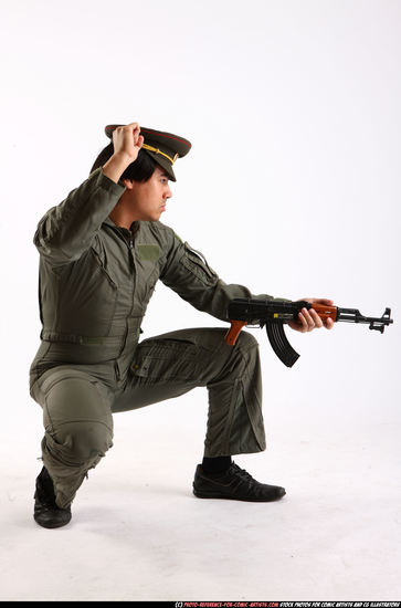 Man Adult Average Fighting with submachine gun Kneeling poses Army Asian