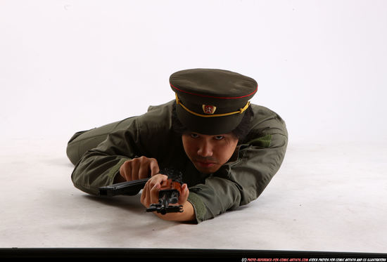 Man Adult Average Fighting with submachine gun Laying poses Army Asian