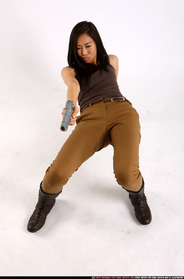 Woman Young Athletic Fighting with gun Laying poses Asian