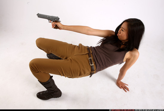 Woman Young Athletic Fighting with gun Laying poses Asian