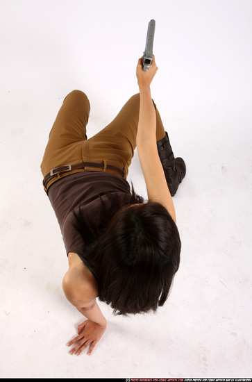 Woman Young Athletic Fighting with gun Laying poses Asian