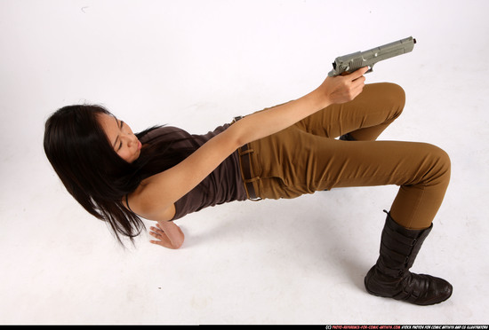 Woman Young Athletic Fighting with gun Laying poses Asian