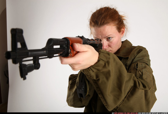 Woman Adult Average White Fighting with submachine gun Standing poses Army