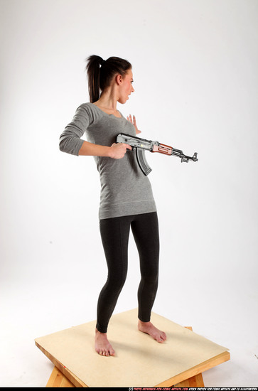 Woman Adult Athletic White Fighting with submachine gun Standing poses Casual