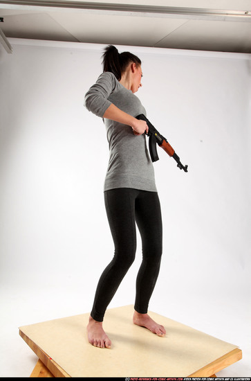 Woman Adult Athletic White Fighting with submachine gun Standing poses Casual