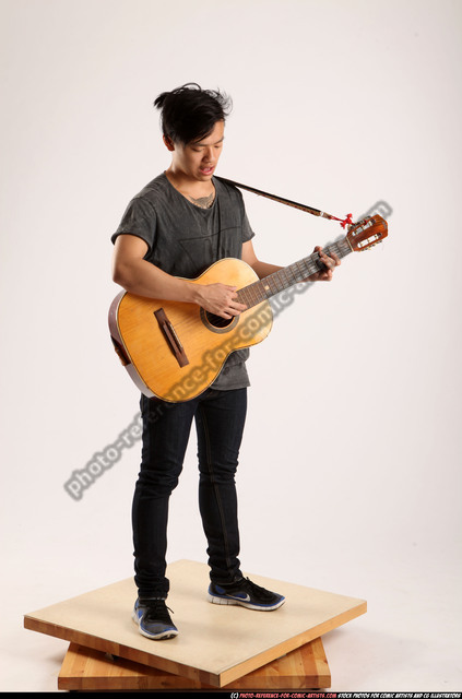 Seated guitarist poses for the camera Stock Photo by ©feedough 84963514