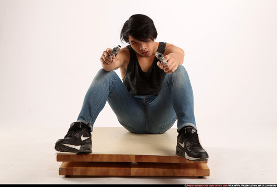 Man Young Athletic Fighting with gun Sitting poses Casual Asian