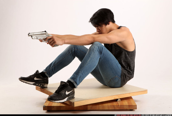 Man Young Athletic Fighting with gun Sitting poses Casual Asian