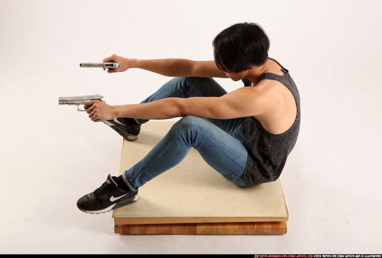 Man Young Athletic Fighting with gun Sitting poses Casual Asian