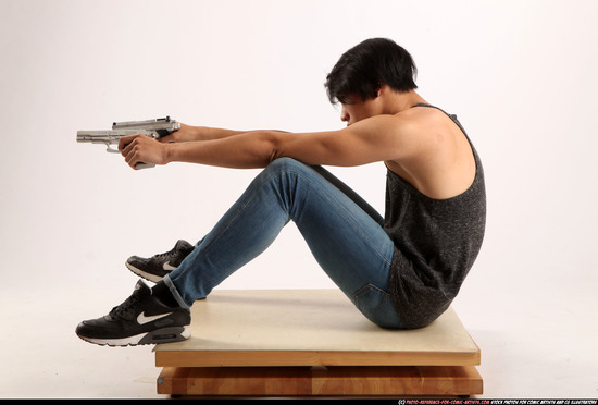 Man Young Athletic Fighting with gun Sitting poses Casual Asian