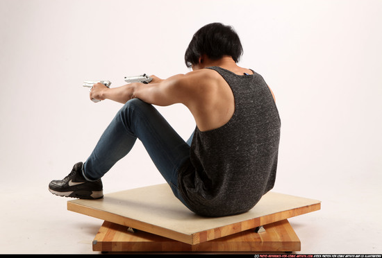 Man Young Athletic Fighting with gun Sitting poses Casual Asian