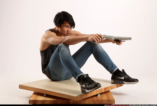 Man Young Athletic Fighting with gun Sitting poses Casual Asian