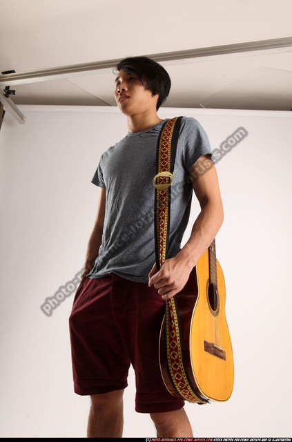 Premium Photo | Young man holding a guitar