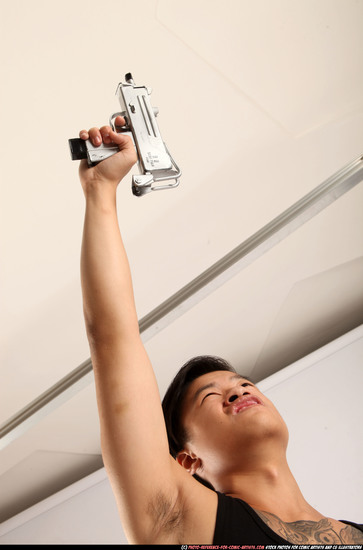 Man Young Athletic Fighting with submachine gun Standing poses Casual Asian