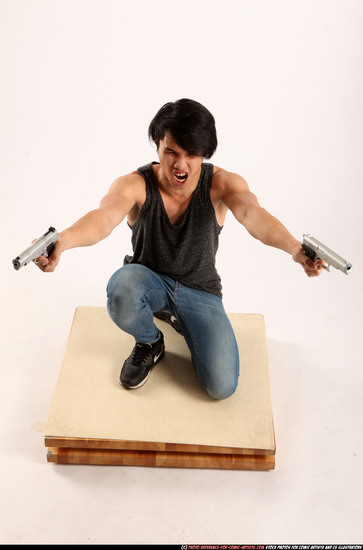 Man Young Athletic Fighting with gun Kneeling poses Casual Asian