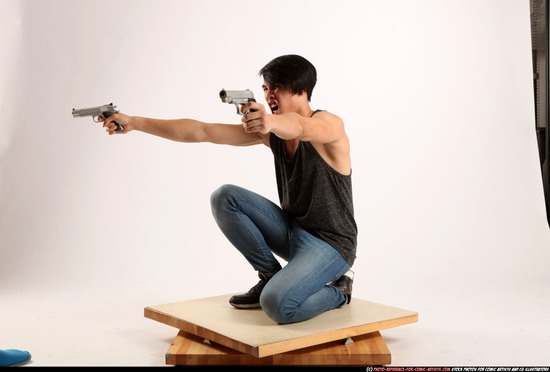 Man Young Athletic Fighting with gun Kneeling poses Casual Asian