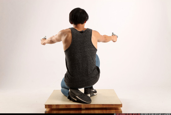 Man Young Athletic Fighting with gun Kneeling poses Casual Asian