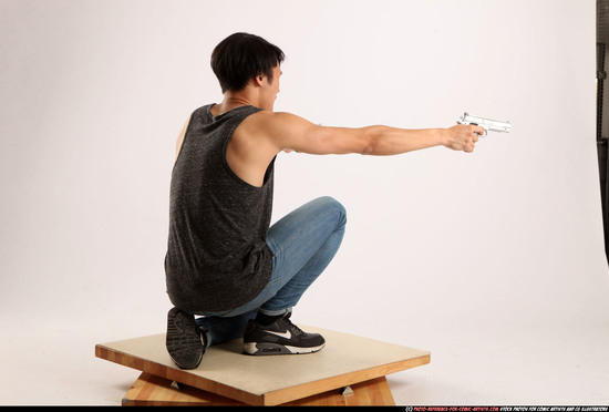 Man Young Athletic Fighting with gun Kneeling poses Casual Asian