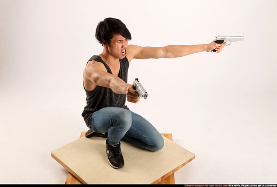 Man Young Athletic Fighting with gun Kneeling poses Casual Asian