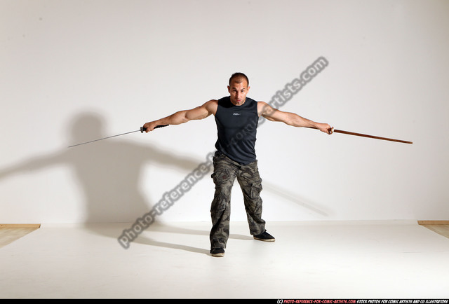 Man Holding Two Swords Looking Away High-Res Stock Photo - Getty Images