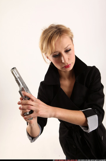 Woman Adult Athletic White Fighting with gun Standing poses Coat