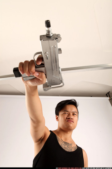 Man Young Athletic Fighting with submachine gun Standing poses Casual Asian