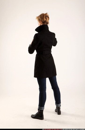 Woman Adult Athletic White Fighting with gun Standing poses Coat