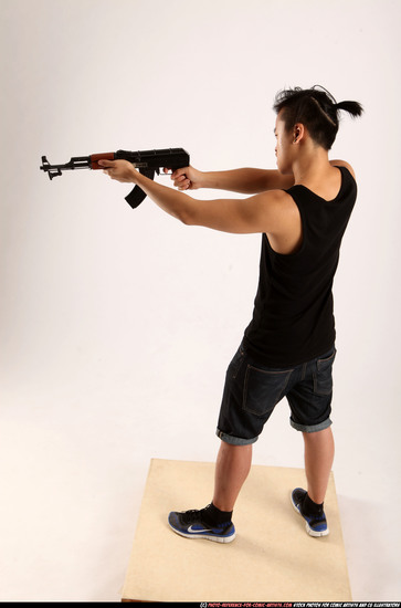 Man Young Athletic Fighting with submachine gun Standing poses Casual Asian