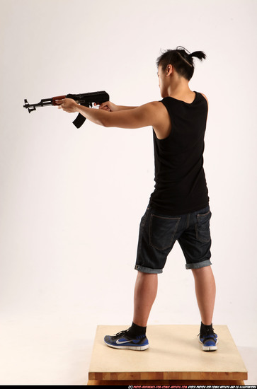 Man Young Athletic Fighting with submachine gun Standing poses Casual Asian