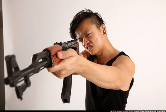 Man Young Athletic Fighting with submachine gun Standing poses Casual Asian