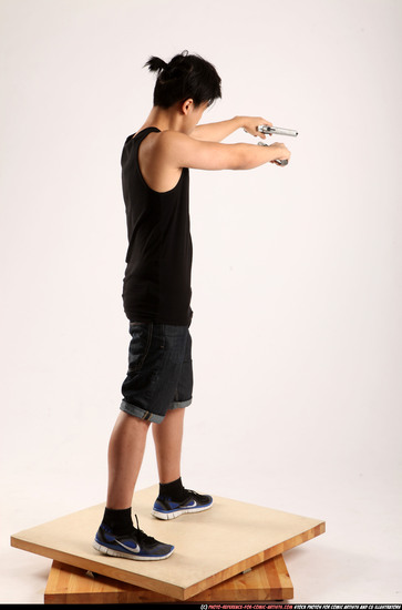 Man Young Athletic Fighting with gun Standing poses Casual Asian