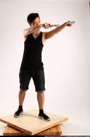 Man Young Athletic Fighting with gun Standing poses Casual Asian