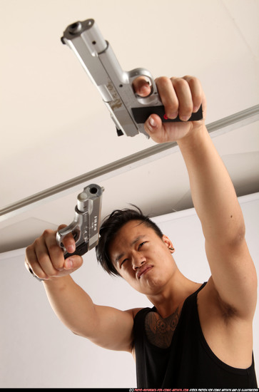 Man Young Athletic Fighting with gun Standing poses Casual Asian