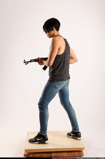 Man Young Athletic Fighting with submachine gun Standing poses Casual Asian