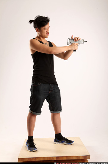 Man Young Athletic Fighting with submachine gun Standing poses Casual Asian