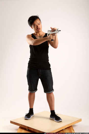 Man Young Athletic Fighting with submachine gun Standing poses Casual Asian