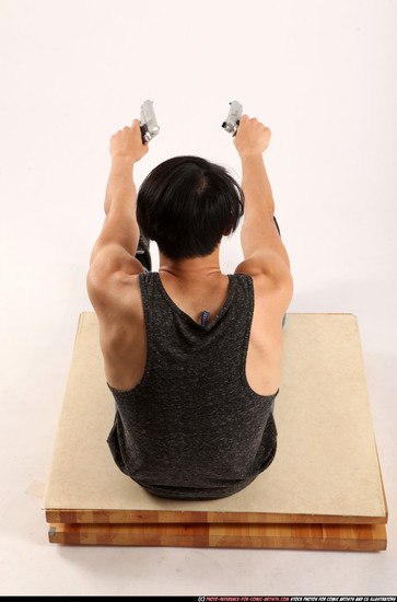 Man Young Athletic Fighting with gun Sitting poses Casual Latino