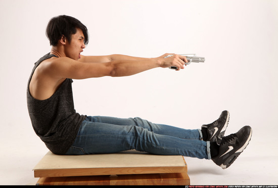 Man Young Athletic Fighting with gun Sitting poses Casual Latino